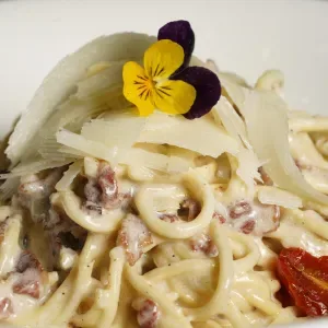 Tagliolini alla carbonara and Parmesan cheese