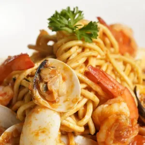 Tagliolini seafood with clam, prawn, calamari in tomato sauce